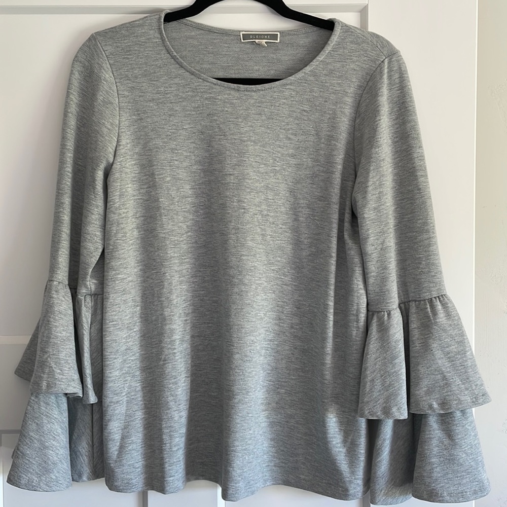 Gray top with layered sleeves. Cute with jeans or skirt! Never worn